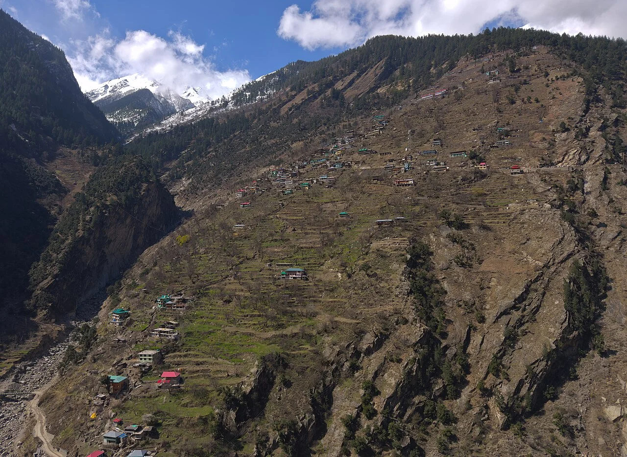 Lush red apple orchards clinging to steep mountain terraces